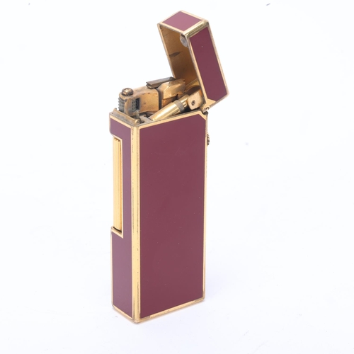 616 - A vintage Dunhill Rollagas lighter, with gold plated and red lacquer body, makers marks to base, len... 