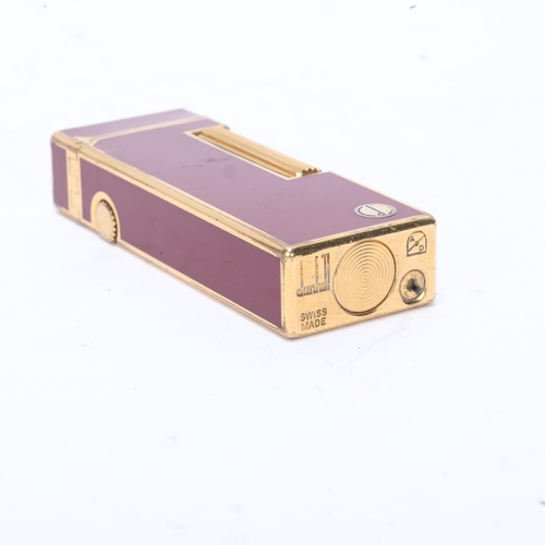 616 - A vintage Dunhill Rollagas lighter, with gold plated and red lacquer body, makers marks to base, len... 