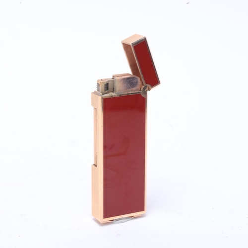 630 - A Dunhill slimline Rollagas lighter, gold plated with red lacquer body, makers marks to base, No1187... 