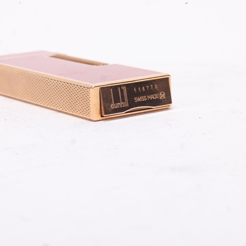 630 - A Dunhill slimline Rollagas lighter, gold plated with red lacquer body, makers marks to base, No1187... 