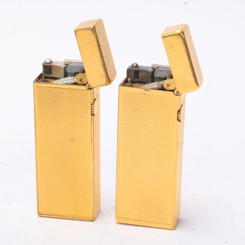 643 - 2 vintage Dunhill gold plated Rollagas lighters, with engine turned bodies, mechanism USA Pat No 165... 