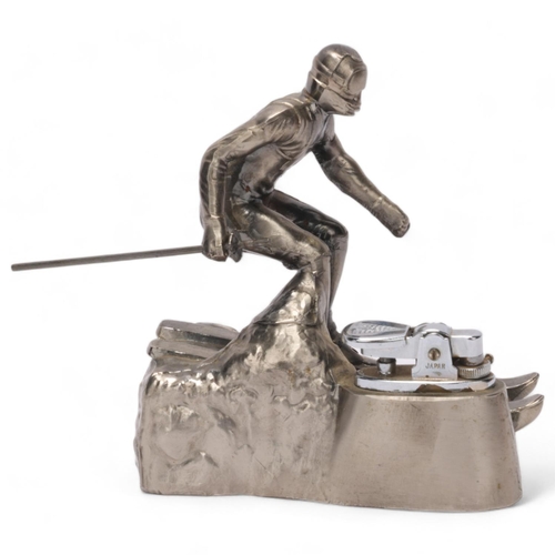 645 - A Comoys table lighter in the form of a downhill skier, aluminium base, height 12.5cm