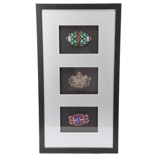 116 - 3 Art Nouveau enamelled and gem set buckles, mounted in good quality modern frame, overall frame dim... 