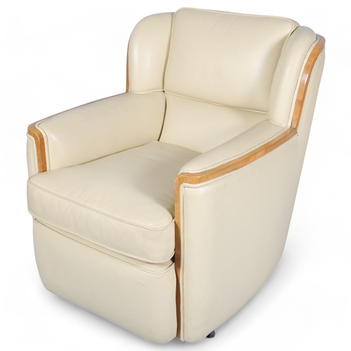 134 - Art Deco cream leather upholstered armchair, with walnut show-wood surround, overall width 68cm