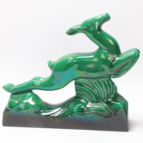 15 - Sainte-Radegonde, Art Deco green glaze pottery leaping deer, impressed marks under base, length 32cm... 