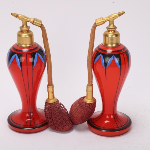 94 - Pair of Art Deco red glass atomiser perfume bottles, with painted decoration and gilt-metal mounts, ... 