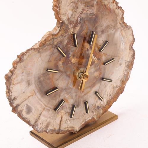 256 - A mid 20th century quartz clock, with a fossilised wood face on brass stand, no makers mark, height ... 