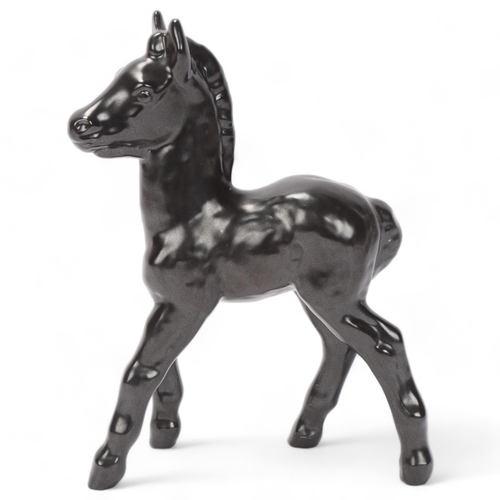 269 - VICKE LINDSTRAND for Upsala Ekeby, Sweden, a figurine of a black foal, design nr 62 in the 1939 figu... 