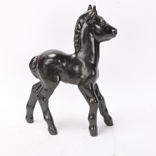 269 - VICKE LINDSTRAND for Upsala Ekeby, Sweden, a figurine of a black foal, design nr 62 in the 1939 figu... 