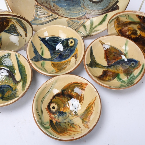 287 - A large earthenware bowl with slipware fish decoration, together with six smaller bowls by the same ... 