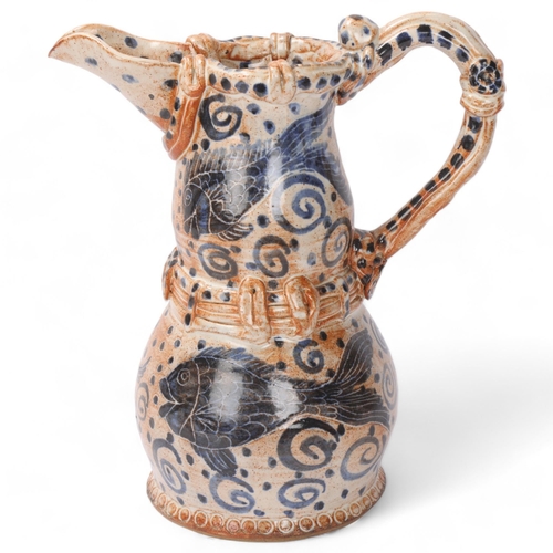 321 - A studio pottery stoneware jug with painted fish decoration, signed to base, height 25cm