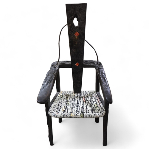 332 - TERRY WARREN, a hand made ebonised driftwood armchair, with marble painted seat and painted insert p... 