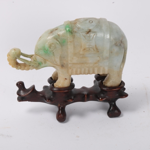 865 - A pair of small Chinese carved jade elephants on carved wood stands, length 10.5cm