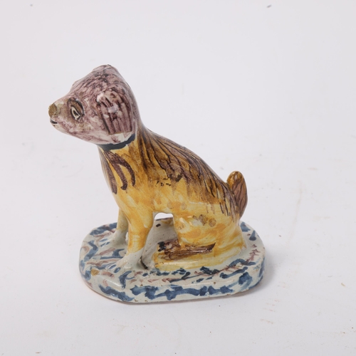 866 - A 19th century Delft pottery dog, height 8.5cm