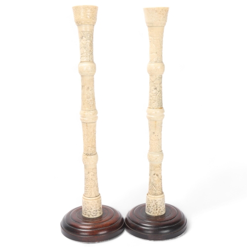 874 - Pair of 19th century Japanese bone multi-section candlesticks on wood bases, height 40cm, 1 A/F