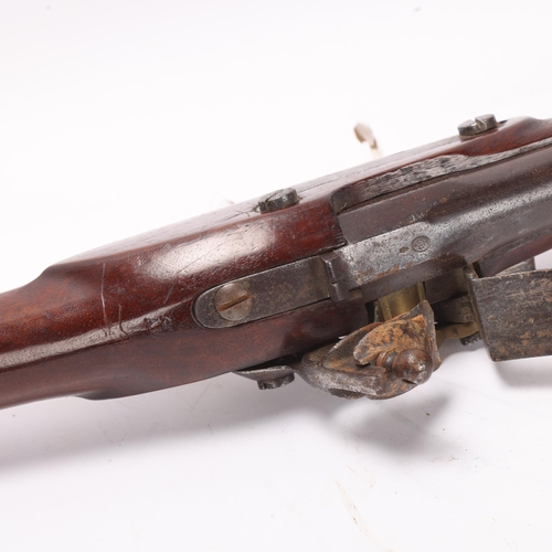 893 - An antique flintlock rifle, with brass bound barrel, makers stamp to barrel, stock marks AM and crow... 