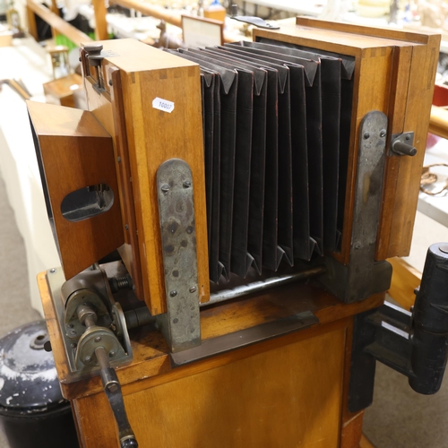 718 - A large Victorian floor standing studio camera, mahogany and brass, with inter-changeable plate size... 