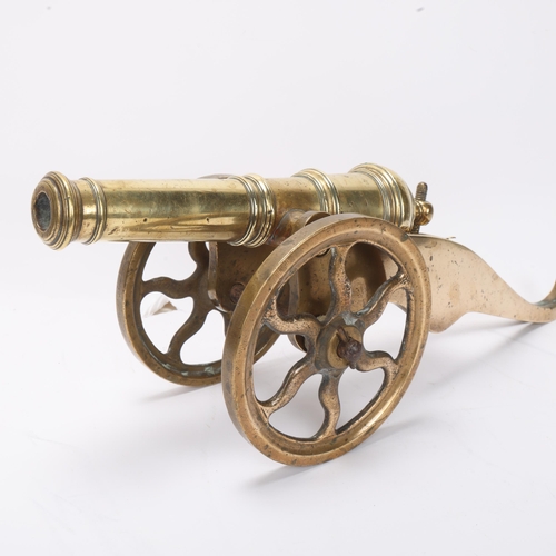 735 - A good quality brass table cannon, 18th or 19th century with ringed barrel on wheeled carriage, barr... 