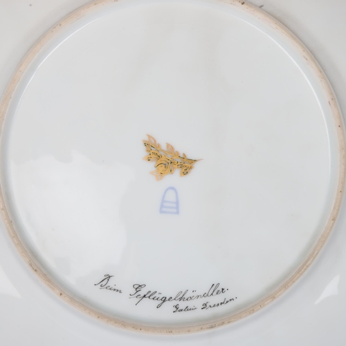 739 - A Vienna porcelain plate depicting a bird handler, gilded border, diameter 25.5cm