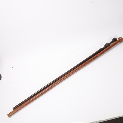 769 - A Zulu lignum vitae ball end stick, length 93cm, and an African hardwood stick with carved head (2)