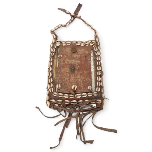 772 - An African Tribal chest plate, with inset mirror decorated with cowrie shells, approx 25cm x 19cm