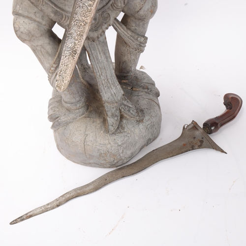 775 - A Malayan carved wood grotesque figure Kris stand, together with a Kris dagger in white metal scabba... 