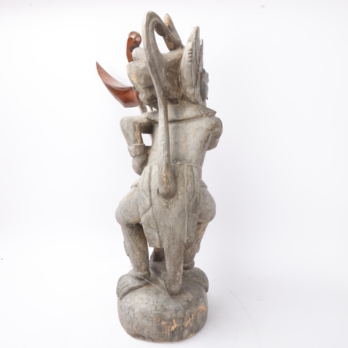 775 - A Malayan carved wood grotesque figure Kris stand, together with a Kris dagger in white metal scabba... 