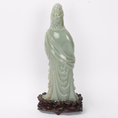 782 - A Chinese carved green jade figure of Guanyin on carved hardwood stand, overall height 32cm, provena... 