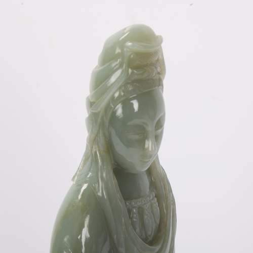 782 - A Chinese carved green jade figure of Guanyin on carved hardwood stand, overall height 32cm, provena... 