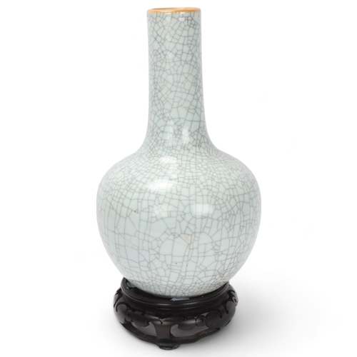 785 - A Chinese crackle glaze porcelain onion-shaped vase on carved wood stand, overall height 39cm