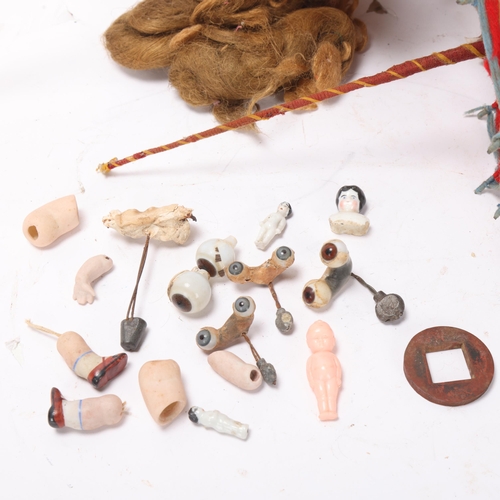 808 - A collection of doll related items, doll's house items, spare limbs, peg doll and a book, The Collec... 