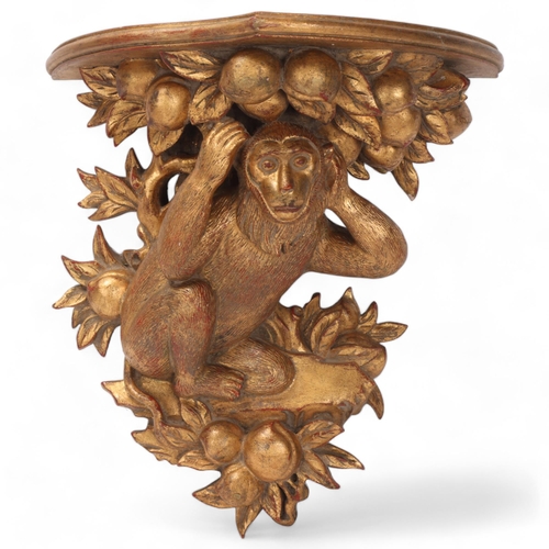 812 - A carved giltwood shelf bracket, supported by a monkey, height 36cm