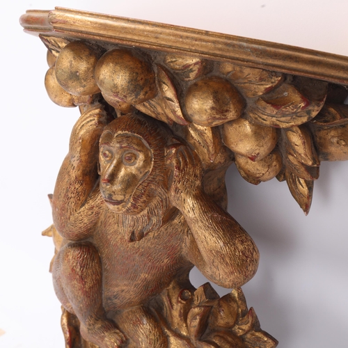 812 - A carved giltwood shelf bracket, supported by a monkey, height 36cm