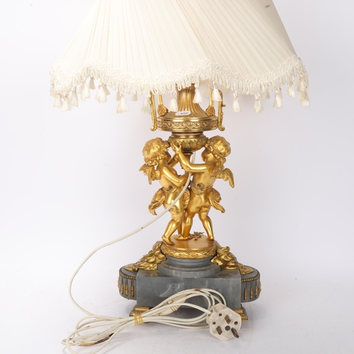 701 - An ornate French gilt-bronze table lamp, supported by 2 cherubs, probably late 19th century, on ormo... 