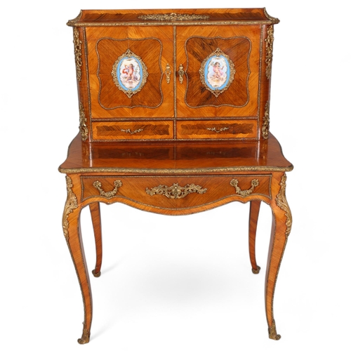 703 - An ornate French kingwood and rosewood writing desk, circa 1900, the upper part fitted with 2 doors ... 