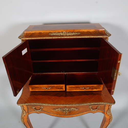 703 - An ornate French kingwood and rosewood writing desk, circa 1900, the upper part fitted with 2 doors ... 