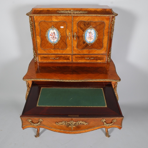 703 - An ornate French kingwood and rosewood writing desk, circa 1900, the upper part fitted with 2 doors ... 