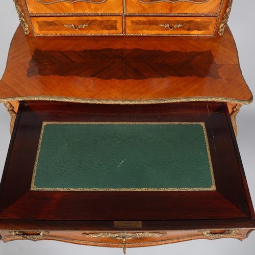 703 - An ornate French kingwood and rosewood writing desk, circa 1900, the upper part fitted with 2 doors ... 