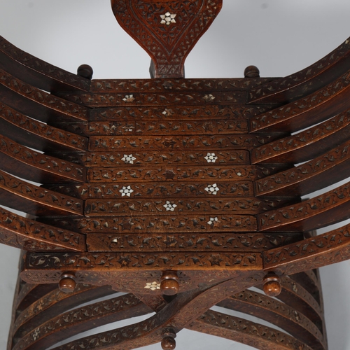 706 - A Damascus X-framed Throne chair, Syria, late 19th century, with carved text to the top rail and inl... 