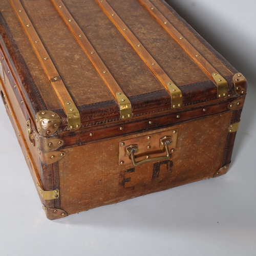 707 - A Vintage French travelling trunk, brass wood and leather-bound with canvas panels, original label i... 