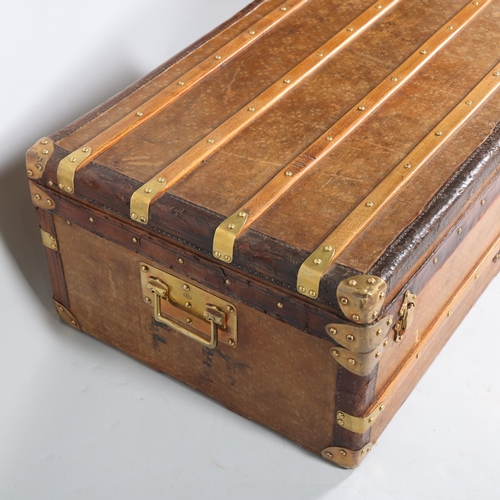 707 - A Vintage French travelling trunk, brass wood and leather-bound with canvas panels, original label i... 