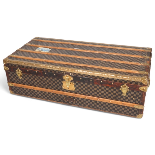 708 - A Vintage French travelling trunk, brass wood and leather-bound with printed canvas panels, Damier p... 