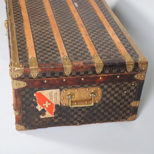 708 - A Vintage French travelling trunk, brass wood and leather-bound with printed canvas panels, Damier p... 