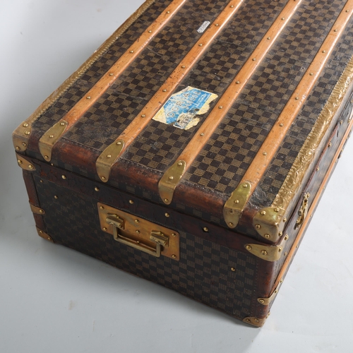 708 - A Vintage French travelling trunk, brass wood and leather-bound with printed canvas panels, Damier p... 