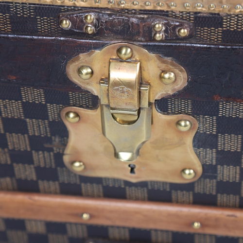 708 - A Vintage French travelling trunk, brass wood and leather-bound with printed canvas panels, Damier p... 