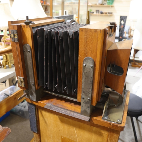 718 - A large Victorian floor standing studio camera, mahogany and brass, with inter-changeable plate size... 