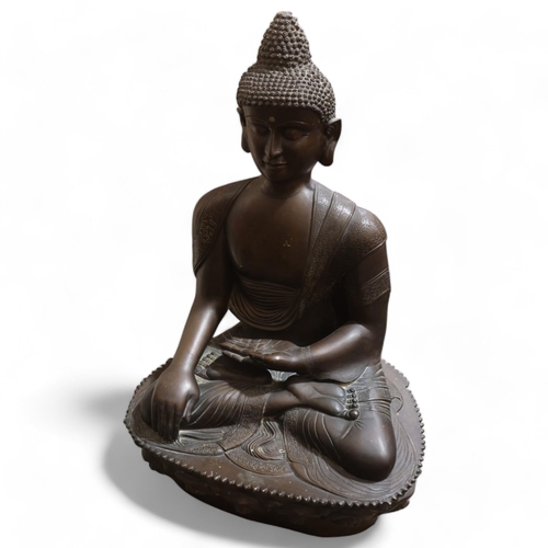 803 - A large Chinese patinated bronze seated Buddha, resting on lotus design base, height 85cm