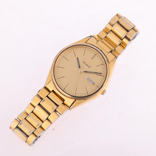 2043 - SEIKO - a gold plated stainless steel SQ quartz bracelet watch, ref. 5H23-8A00, champagne dial with ... 