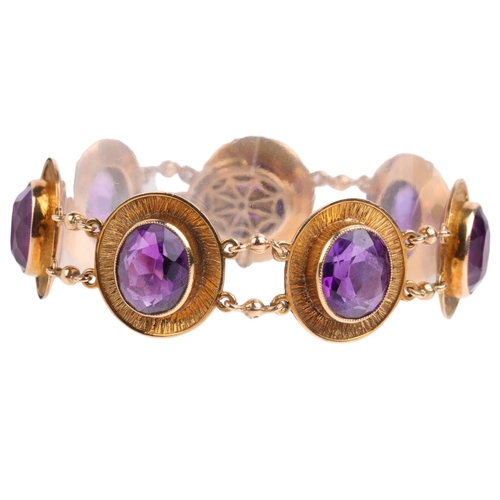 2121 - A 1970s 9ct gold amethyst panel bracelet, maker JR, Birmingham 1974, each oval panel rub-over set wi... 