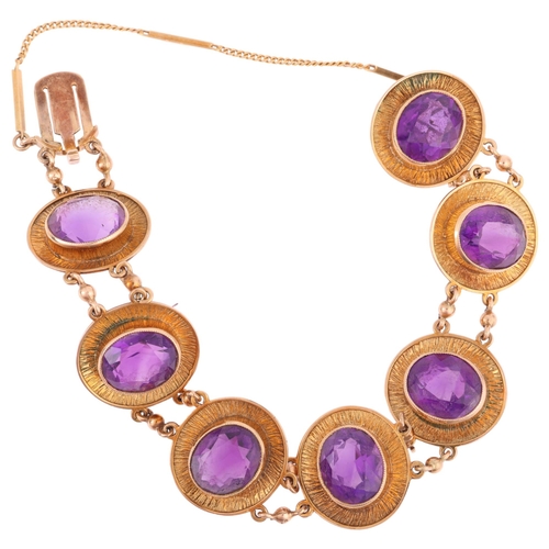2121 - A 1970s 9ct gold amethyst panel bracelet, maker JR, Birmingham 1974, each oval panel rub-over set wi... 